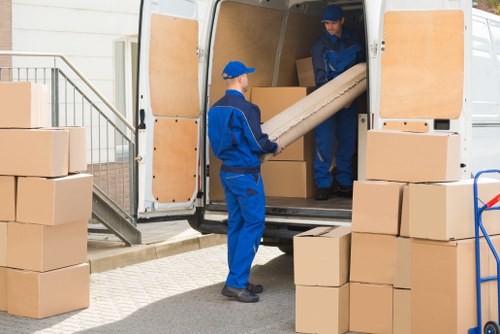 Local student removals team handling boxes and furniture in Queens Park