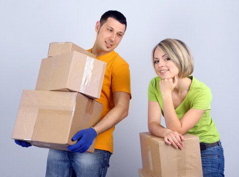 Professional movers handling office equipment and boxes