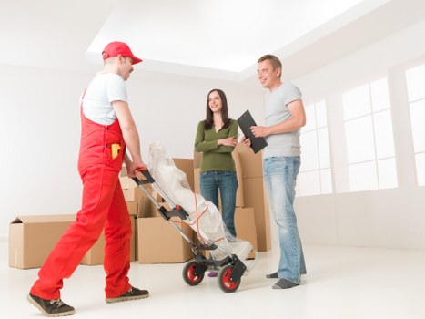 Professional removals team handling office equipment in Queens Park