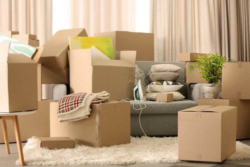 Packed apartment furniture and boxes ready for collection in Queens Park