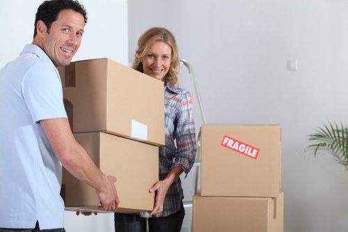 Local movers loading household furniture for an urgent Queens Park relocation